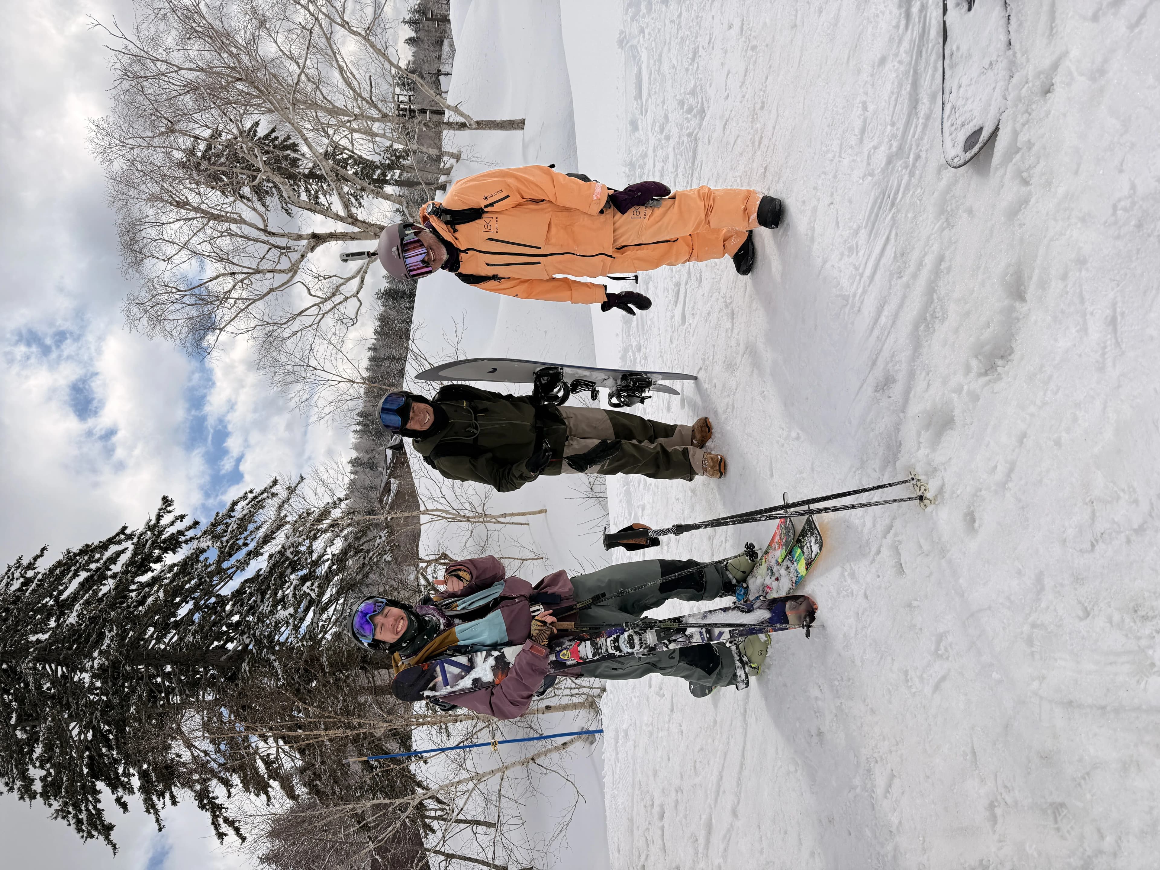 Skiers and snowboarders on a snowy slope near Tomamu.