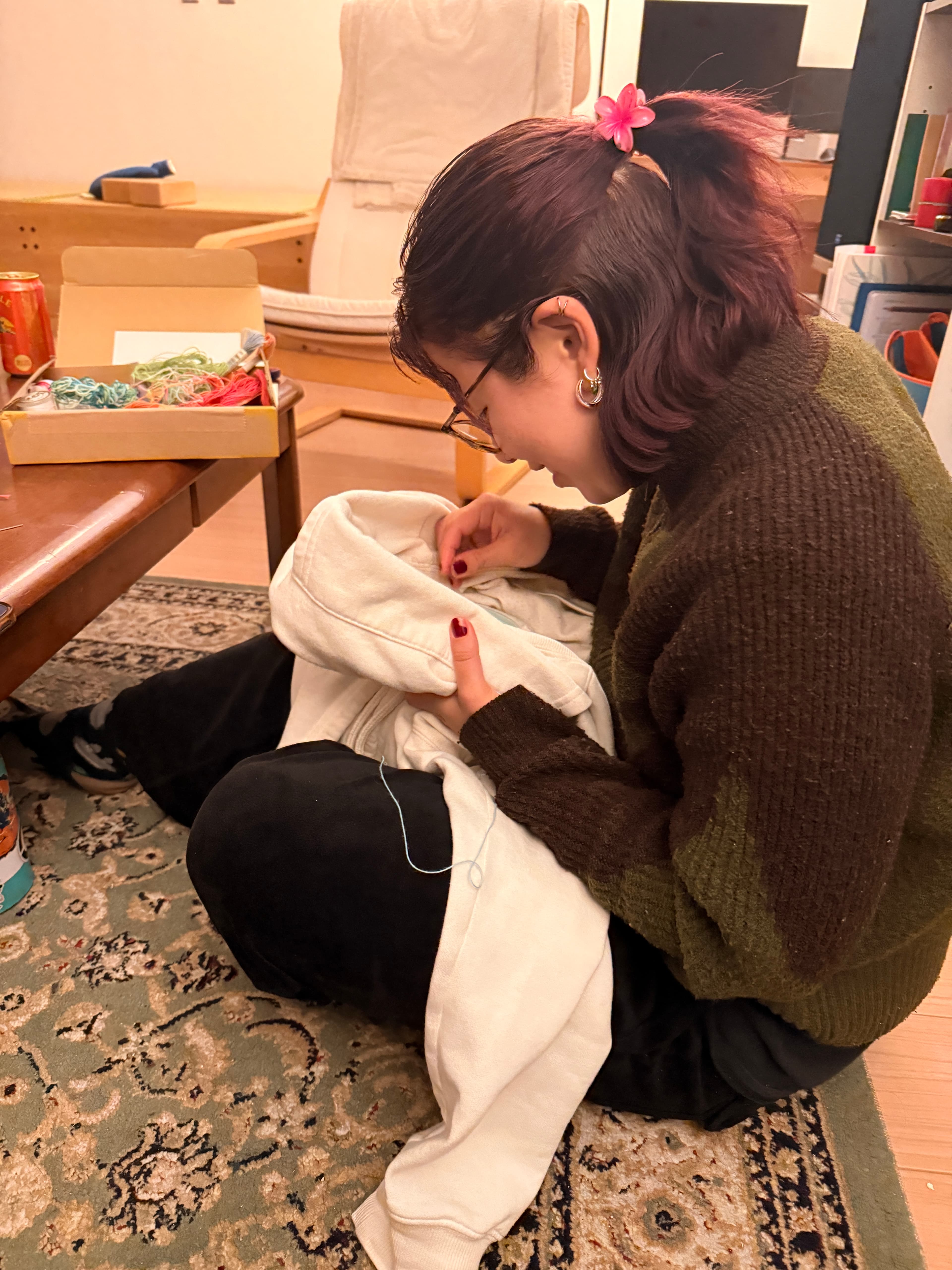 Someone embroidering quietly at the lodge.