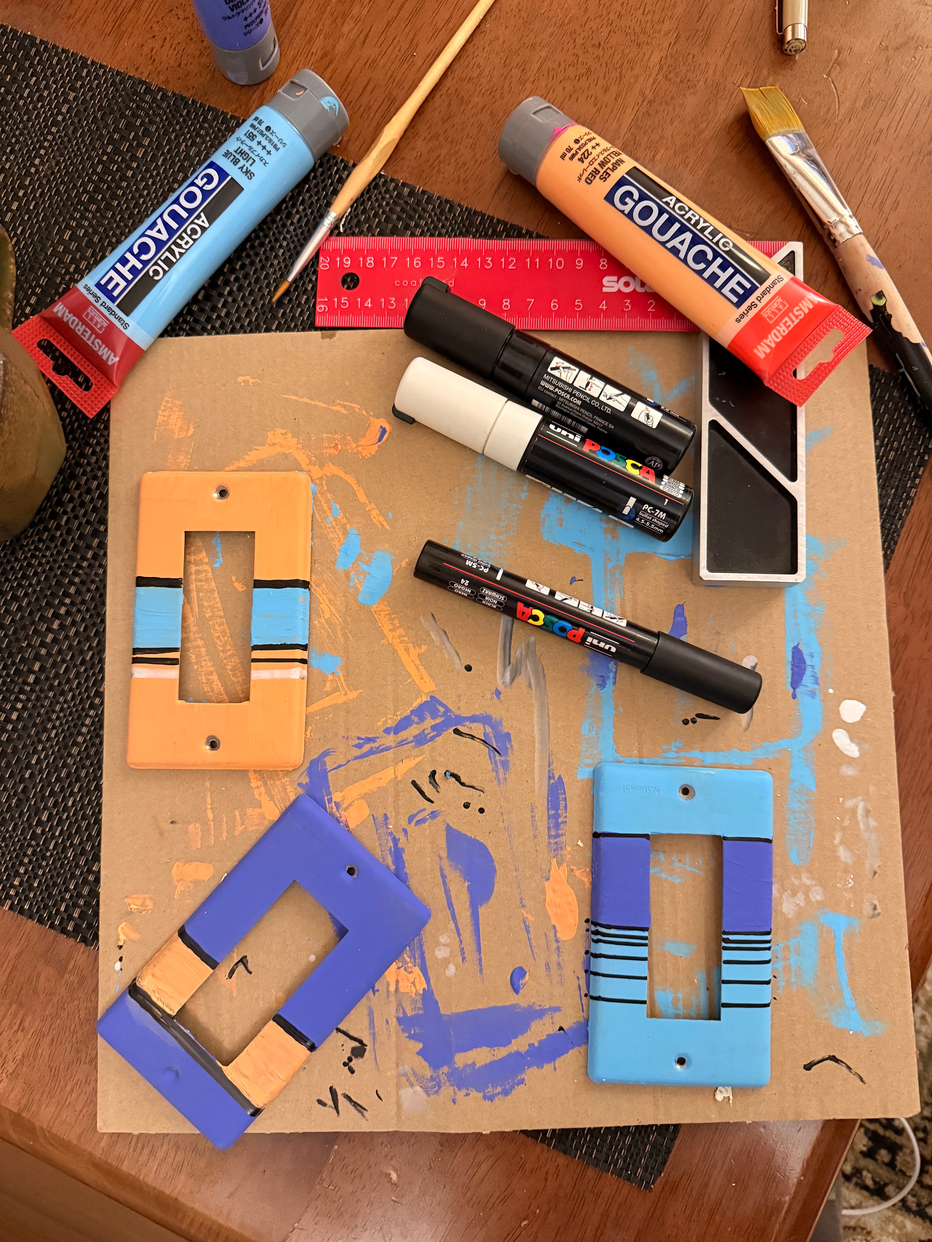 Hand-painted light switch covers in progress at the lodge