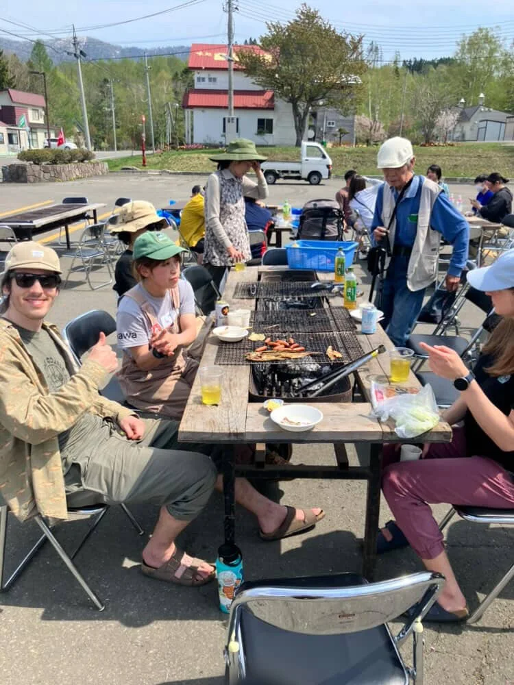 town barbecue gathering with neighbors on a sunny spring day