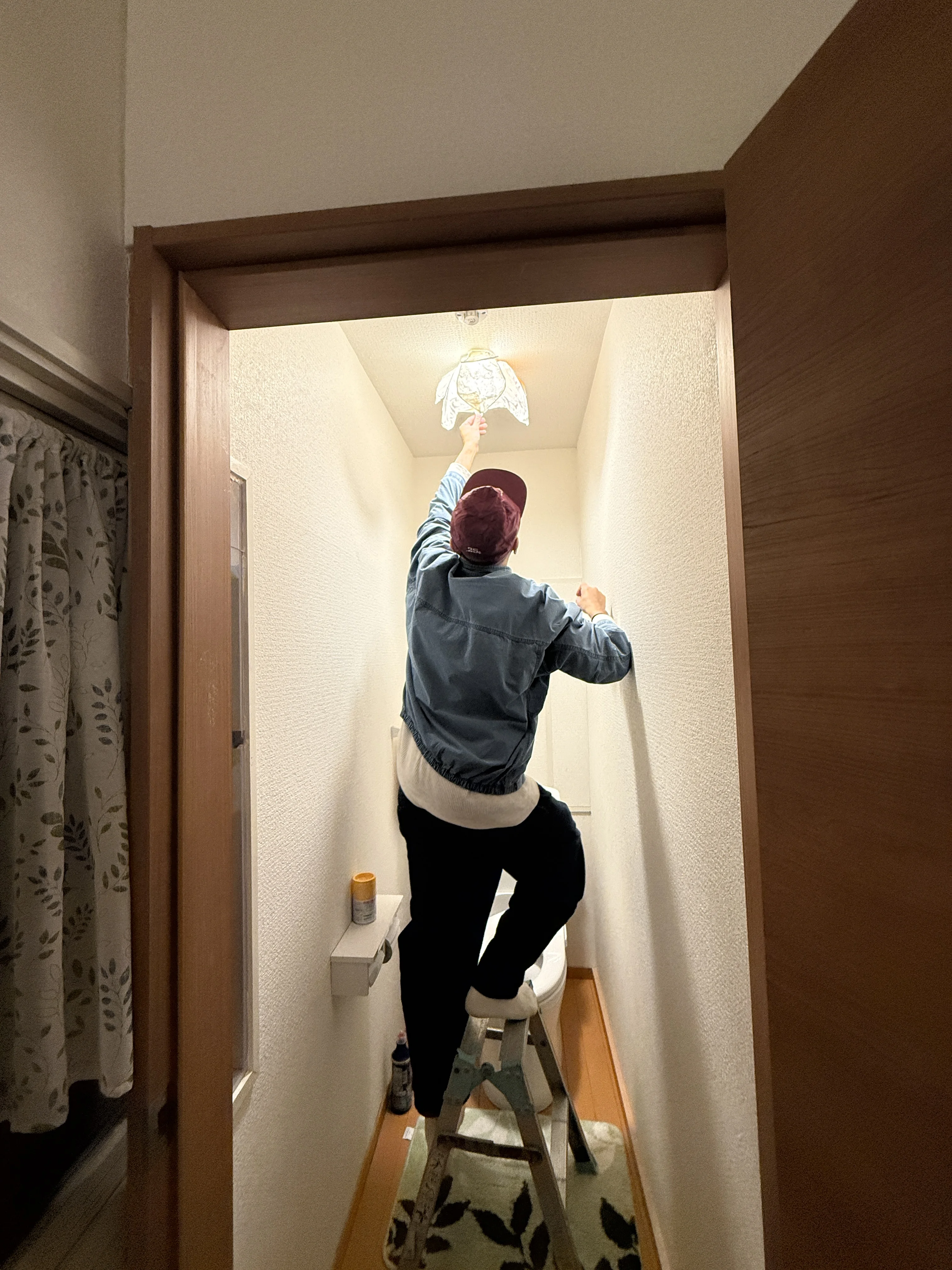 installing a lamp shade at the lodge