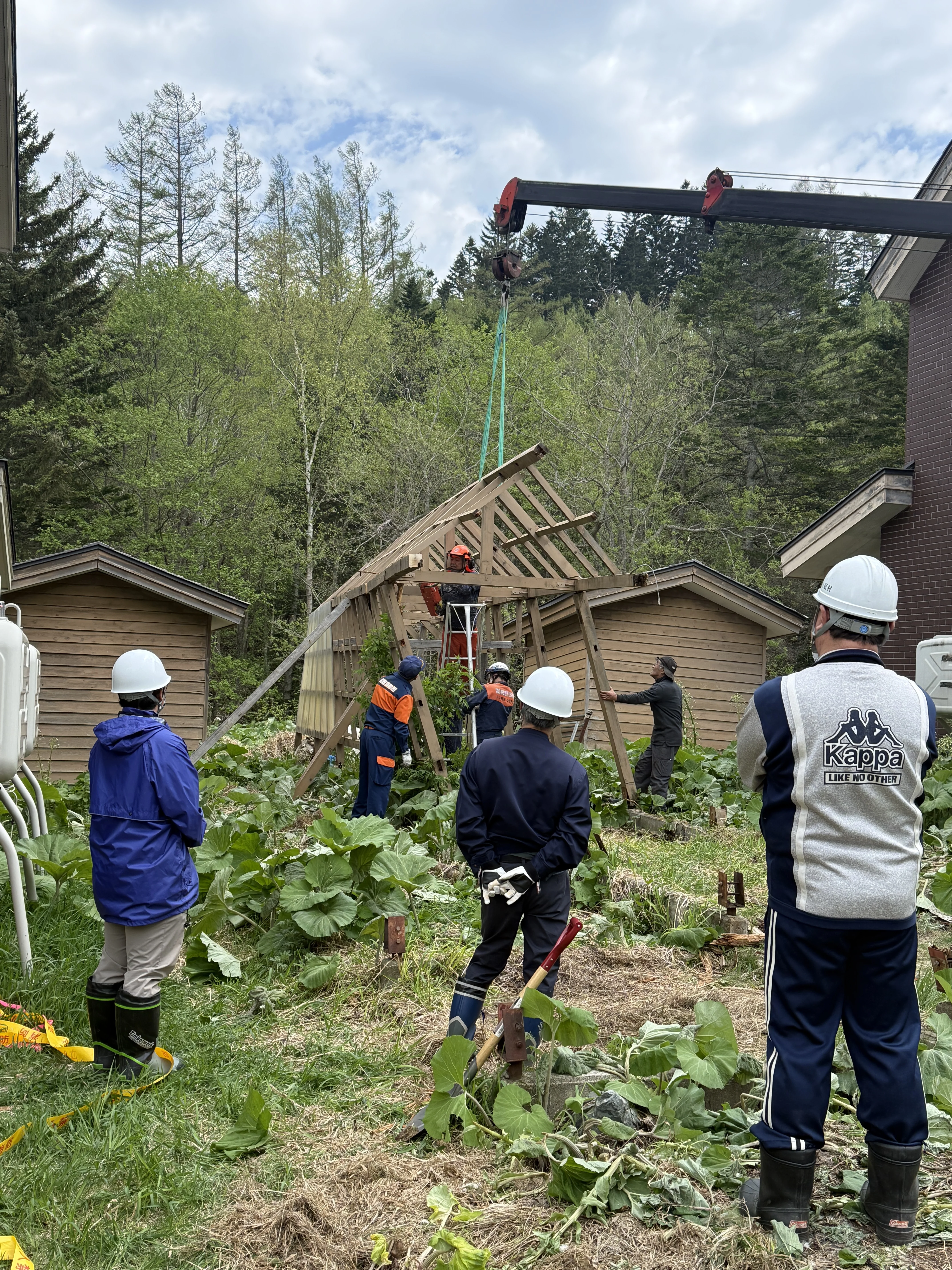 town crew dismantling the collapsed structure next to the lodge