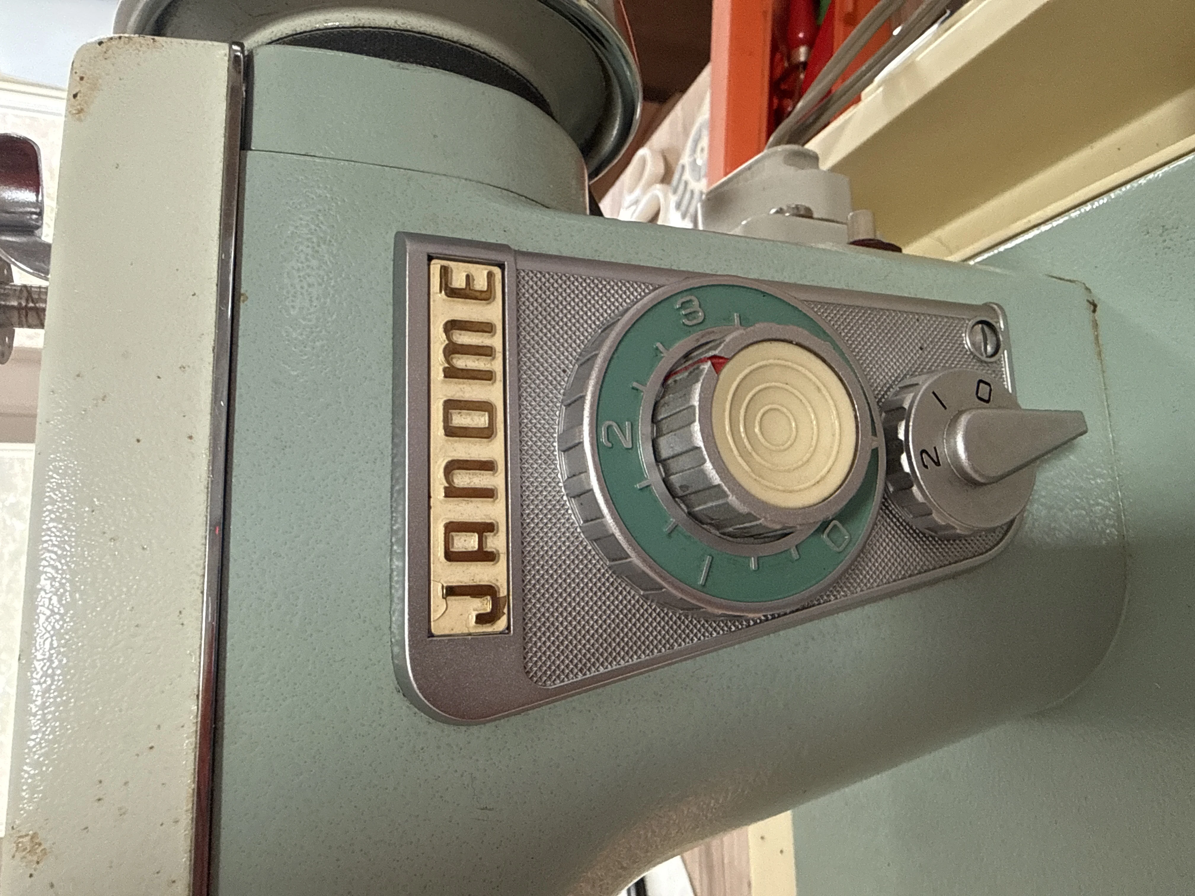 Vintage Janome sewing machine in seafoam green, dial and brand plate